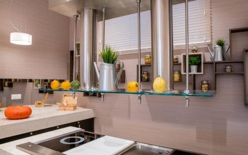 a kitchen with a sink and a counter with some plants at Holiday Inn Dąbrowa Górnicza-Katowice by IHG in Dąbrowa Górnicza