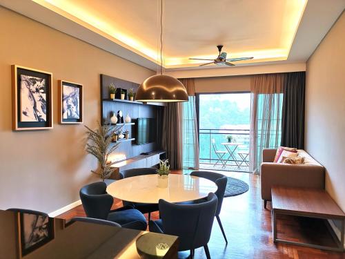 a living room with a table and chairs at ELECTUS HOME at Vista Residences Genting - FREE WiFi & TV Box & Parking in Genting Highlands
