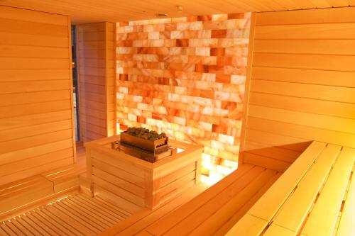 a small wooden sauna with a potted plant in it at Baltic Beach Hotel & SPA in Jūrmala