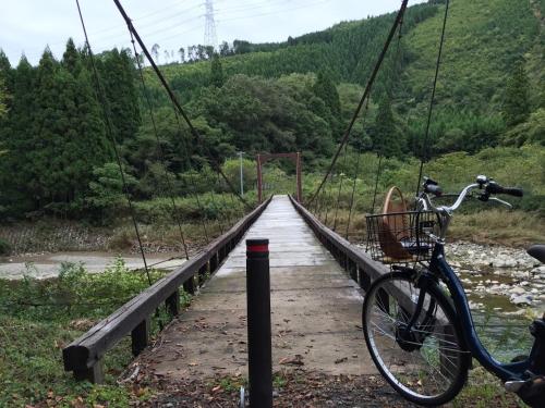 a bike parked on a bridge over a river at Goemon Kyoto Japan in Kyoto