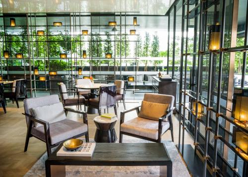 a restaurant with chairs and tables and windows at InterContinental Singapore Robertson Quay by IHG in Singapore