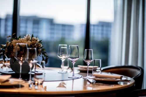 a table with wine glasses on a table with a window at InterContinental Singapore Robertson Quay by IHG in Singapore