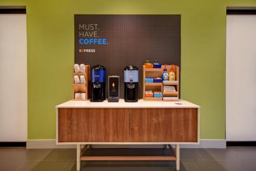 a counter with coffee items on it in a room at Holiday Inn Express & Suites - Galveston Beach, an IHG Hotel in Galveston
