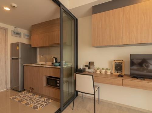 a kitchen with a table and a chair in a room at La casita Hua-Hin seaview by Yaya in Hua Hin