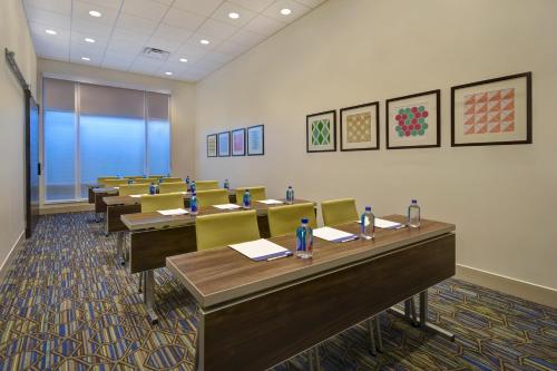 a classroom with rows of tables and chairs at Holiday Inn Express & Suites - Galveston Beach by IHG in Galveston