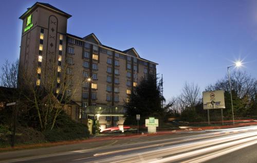 a building with a clock tower next to a street at Holiday Inn Slough Windsor by IHG in Slough
