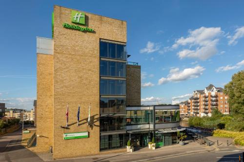 a building with a sign on the side of it at Holiday Inn London Brentford Lock by IHG in Brentford