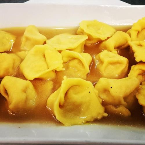 a plate of food with dumplings in a sauce at Rosa Dei Venti in Lugo