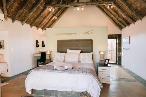 A bed or beds in a room at Tshukudiba Game Lodge