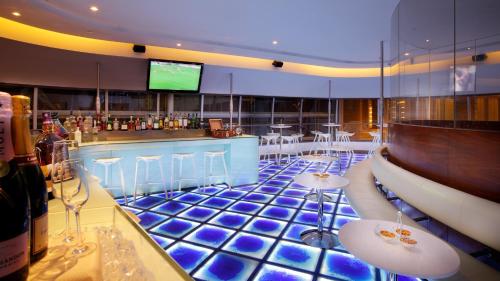 a bar with a blue tiled floor and bar stools at InterContinental Nanjing by IHG in Nanjing