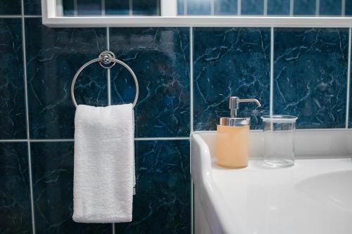 a towel hanging from a faucet next to a sink at Barko Residence 1 in Braşov