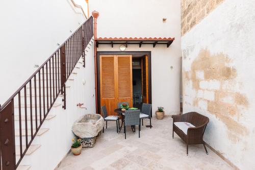 a balcony with a table and chairs on a building at Iolanda Vacanze in Lucugnano