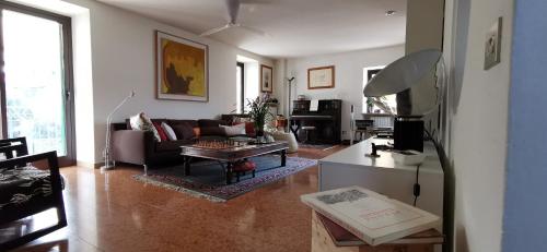 a living room with a couch and a table at A Casa di Tom in SantʼAmbrogio di Valpolicella