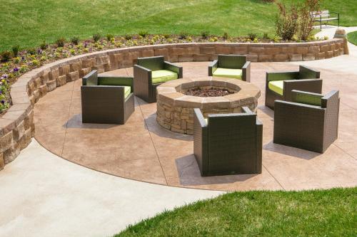 a circular patio with chairs and a fire pit at Holiday Inn Wichita East I-35 by IHG in Wichita