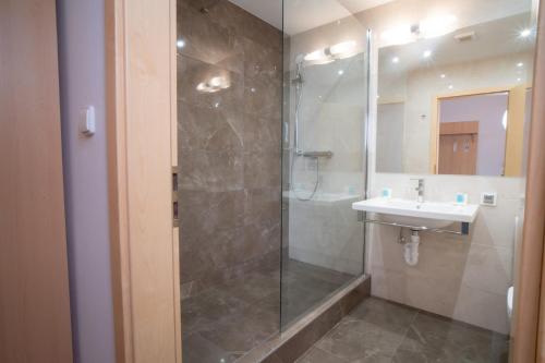 a bathroom with a shower and a sink at TeleDom Hotel in Košice