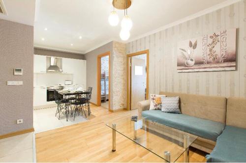 a living room with a couch and a table at CTS Elysium Residence Taksim in Istanbul