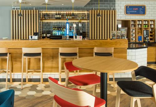 a restaurant with a table and chairs and a bar at Holiday Inn Express Bristol City Centre by IHG in Bristol