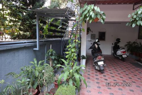 two motorcycles parked in the courtyard of a house at Sandra's Home in Ernakulam