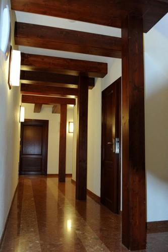 a hallway with wooden beams in a building at Hradná stráž Hotel&Apartments s privátnym wellness in Topoľčianky