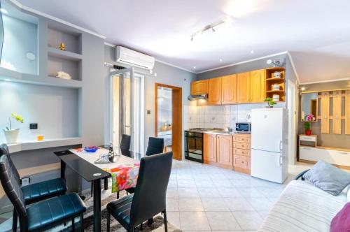 a kitchen and living room with a table and chairs at Apartment in Crikvenica 27606 in Crikvenica