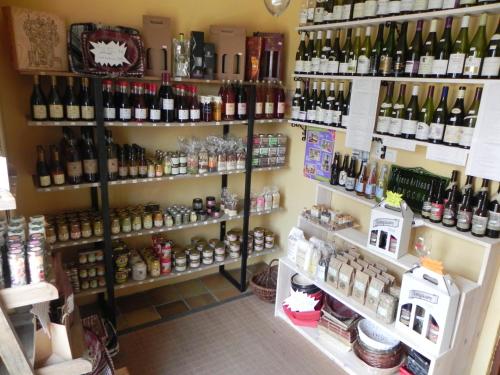 a store filled with lots of bottles of wine at Aux Mésanges in Labergement-Foigney