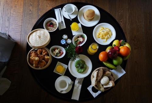 a table topped with plates of food on top of a wooden table at CoolRooms Palacio Villapanés in Seville