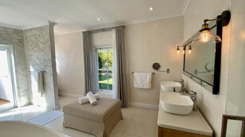 a bathroom with a sink and a toilet and a mirror at La Paris Estate in Franschhoek