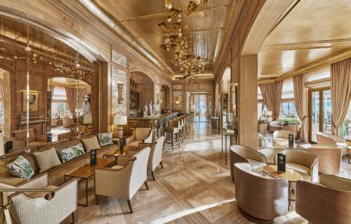 a lobby of a hotel with tables and chairs at La Réserve de Beaulieu in Beaulieu-sur-Mer