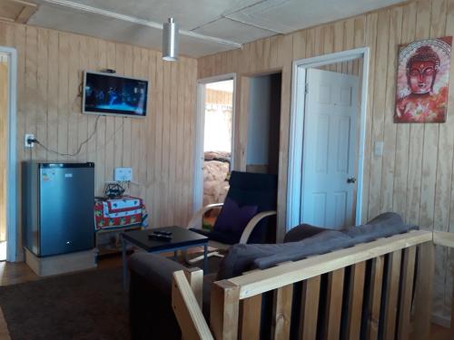a living room with a couch and a table at Descanso Sureño Hospedaje in Valdivia