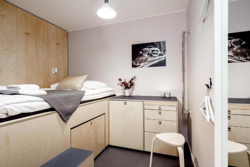 a small bedroom with a bed and a desk at Forenom Hotels & Apartments Arlanda in Arlanda