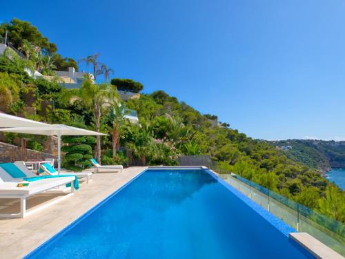 a villa with a swimming pool and a mountain at Villa Emma on the Roc by Interhome in Jávea