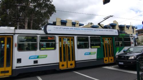 a bus with yellow doors on a city street at Pathfinder Motel in Melbourne