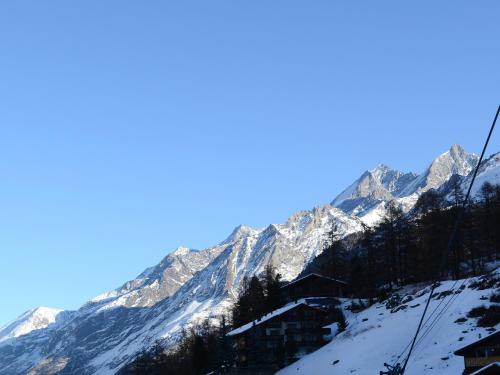 a ski lodge in the mountains with snow at Hotel Plateau Rosa in Zermatt