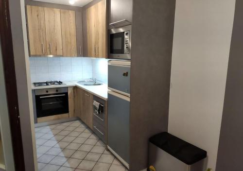 a small kitchen with a sink and a stove at Apartment in quiet area with free parking in Varaždin