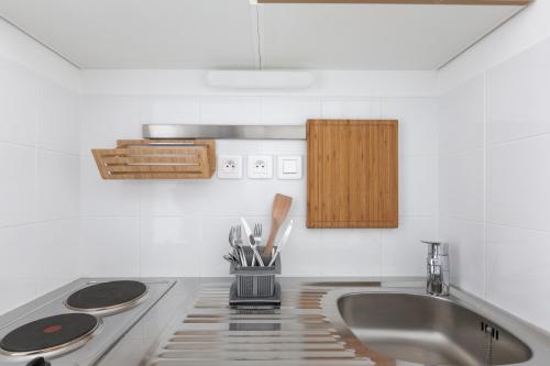 a kitchen counter with a sink and a stove at Student Factory Paris Bagnolet in Bagnolet