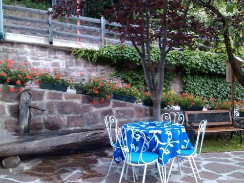 a blue and white table and chairs next to a wall at Hotel Villa Emilia in Ortisei