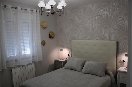 a bedroom with a bed and a chandelier at CASA AMABLE in La Roza