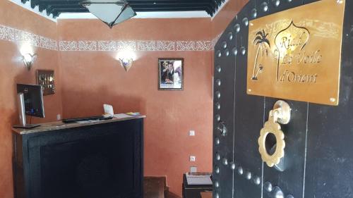 Una habitación con chimenea y un cartel en la pared. en Riad le Voile d'Orient, en Marrakech