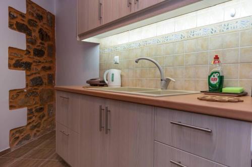 a kitchen with a sink and a bottle of coke at Paraspori Traditional Home with View in Paraspórion