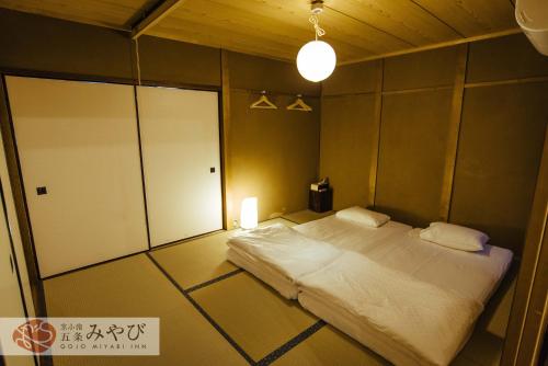 a bedroom with a large bed in a room at Gojo Miyabi Inn in Kyoto