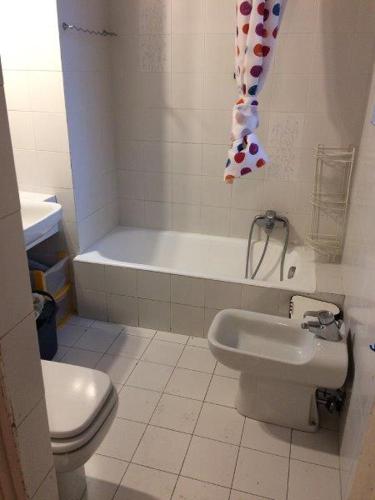 a bathroom with a toilet and a sink and a tub at Martina in Turin