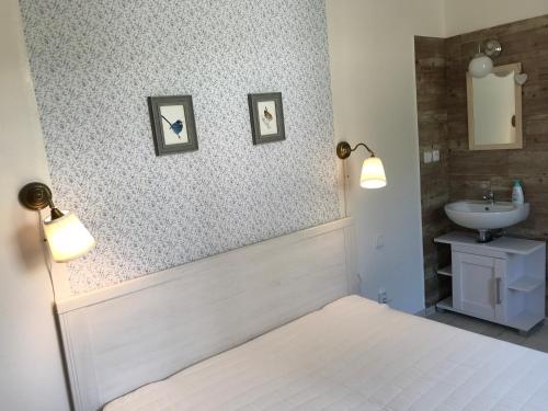a bathroom with a bed and a sink at Chalupa U Kačírků in Horní Planá