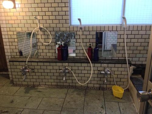 a bathroom with two water faucets and a sink at Naeba Musashi in Yuzawa