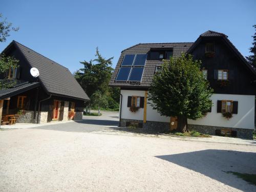 a house with windows and a tree in front of it at Rustic Inn River 2 in Plitvička Jezera