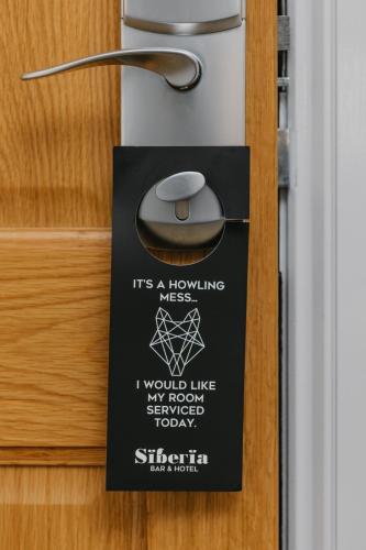 a sign on a door with a mouse on it at Siberia Bar & Hotel in Aberdeen