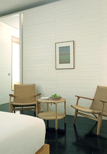 a bedroom with two chairs and a table and a bed at Atrio in Cáceres