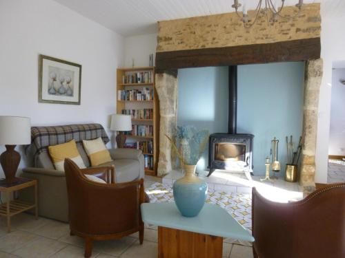 a living room with a couch and a fireplace at La Banne Nord in Cendrieux