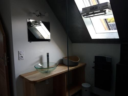 a bathroom with a bowl on a counter with a window at LA MAISON DE JADE in Soursac