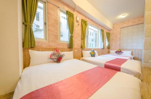 Postel nebo postele na pokoji v ubytování Sweet B&B 幸福微甜民宿