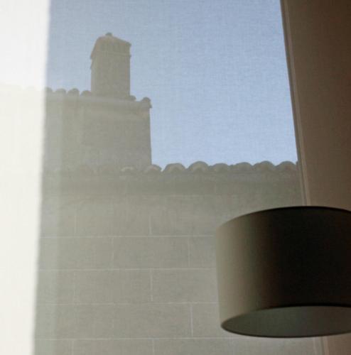 a view of a lighthouse from a window at Atrio in Cáceres